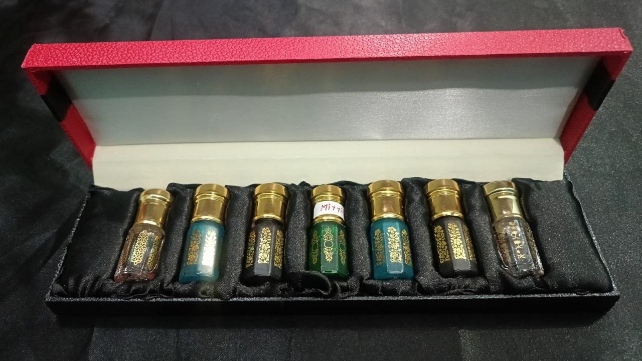 Recycled glass perfume bottle with cork stopper on moss and resin, highlighting sustainable packaging