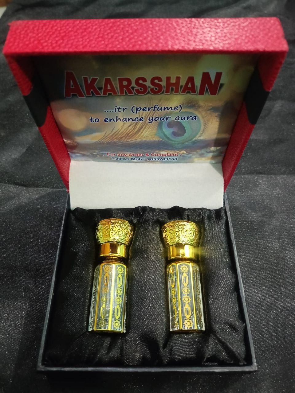 AKARSHAN glass perfume bottle on wooden tray with jasmine and rose petals, soft golden aura glowu0022